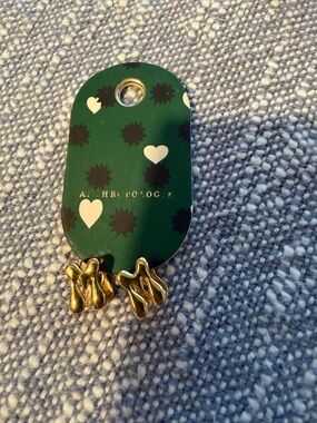 Anthropologie Gold M Drop Earrings on Green Heart Display